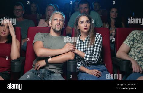 Shocked Couple Watching Terrible Scene At Horror Film Feeling Scared