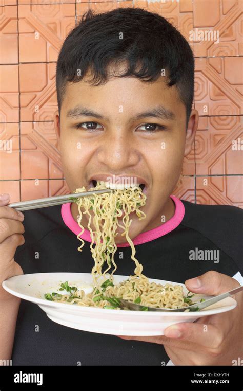 Thai Teen Boy Eating Noodle Stock Photo Alamy