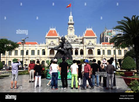 Statue of Ho Chi Minh and Asian tourists at City Hall, Ho Chi Minh City ...