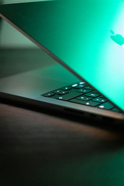 A Close Up Of An Apple Laptop On A Table Photo Free Laptop Image On