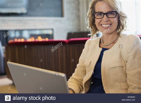 Portrait Of Happy Businesswoman Sitting In Hotel Lobby Stock Photo Alamy