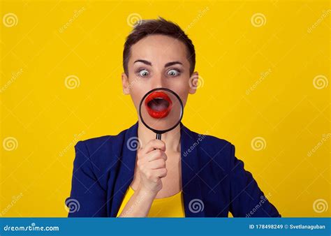 Amazed Surprised Woman Looking Down With Magnifying Glass On Mouth