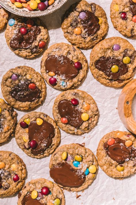 Chocolate Chip Cookies With M And Ms And Candy On Top Are Ready To Be Eaten