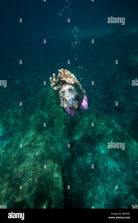 Woman With A Snorkel And Diving Goggles Scuba Diving In The Sea