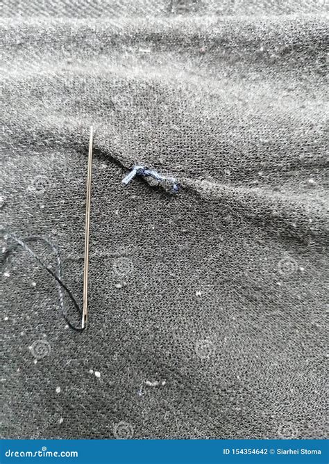 Sewing Needle With Black Thread On A Gray Fabric Stock Photo Image Of