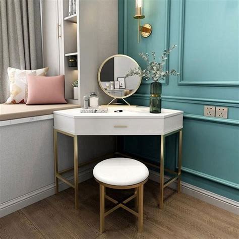 A Dressing Table With A Mirror And Stool In Front Of A Blue Painted Wall Next To A Window