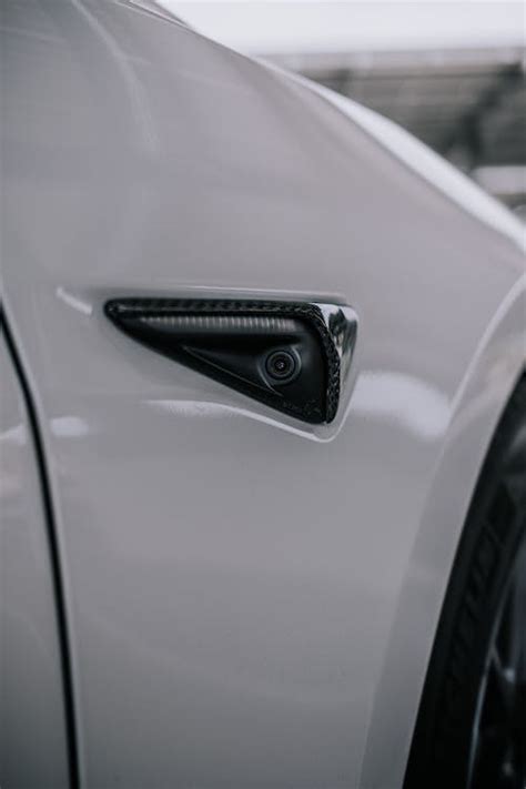 Close-Up Shot of a Tesla Side Camera Carbon Fiber · Free Stock Photo