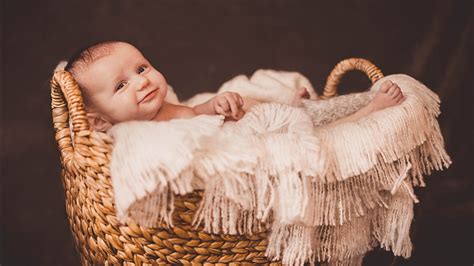 Cute Baby Child Inside Bamboo Basket Covering With White Woolen Knitted