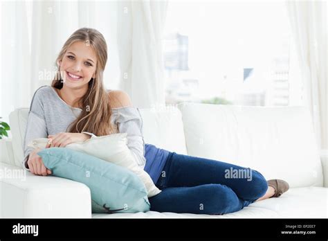 A Smiling Girl Lying On The Couch Facing The Camera Stock Photo Alamy