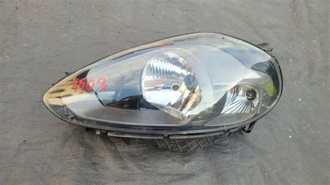 FIAT GRANDE PUNTO EVO LAMPA PRZEDNIA LEWA REFLEKTOR LEWY 89102044SX