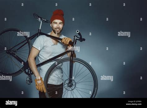 A Male Bicyclist Riding A Bicycle Isolated Against Black Background