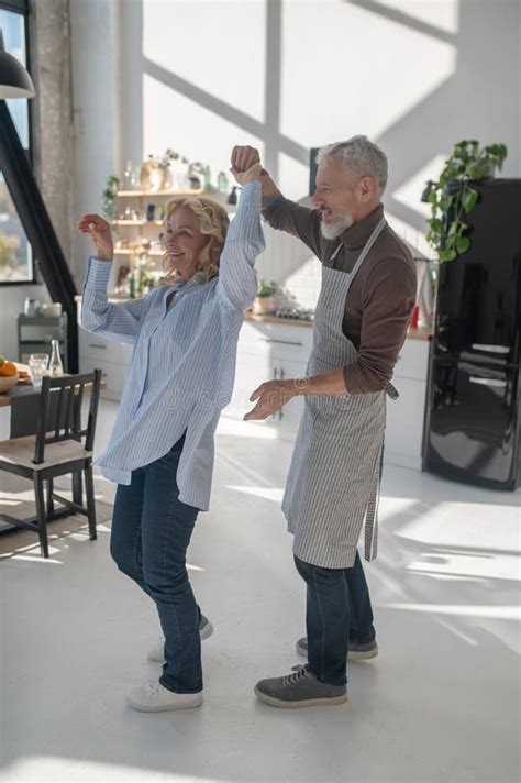 A Mature Couple Dancing In The Kitchen Stock Image Image Of Interior