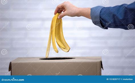 Hand Throwing Banana Peel Into Trash Bin Recycling Waste Sorting