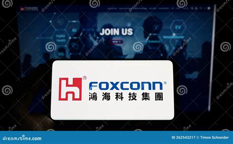 person holding smartphone  logo  hon hai precision industry