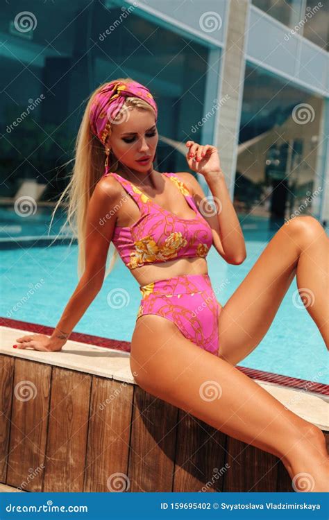 Beautiful Girl With Blond Hair In Elegant Swimming Suit And Accessories