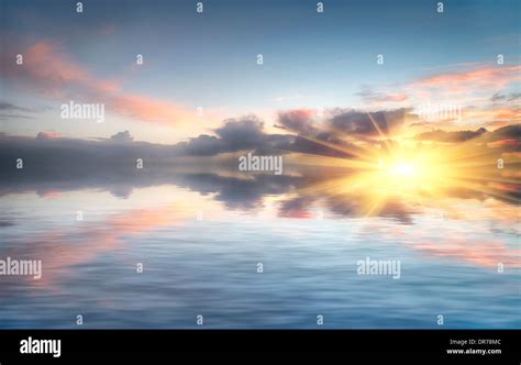 Sunset Sky Reflected Over Water Stock Photo Alamy