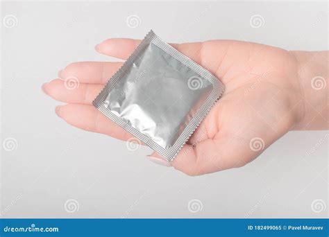 Condom In Young Woman Hand Holding Give Safe Sex Concept Prevent