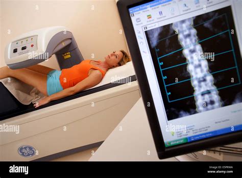 A Doctor Uses A Bone Densitometer To Measure The Optical Density Of The