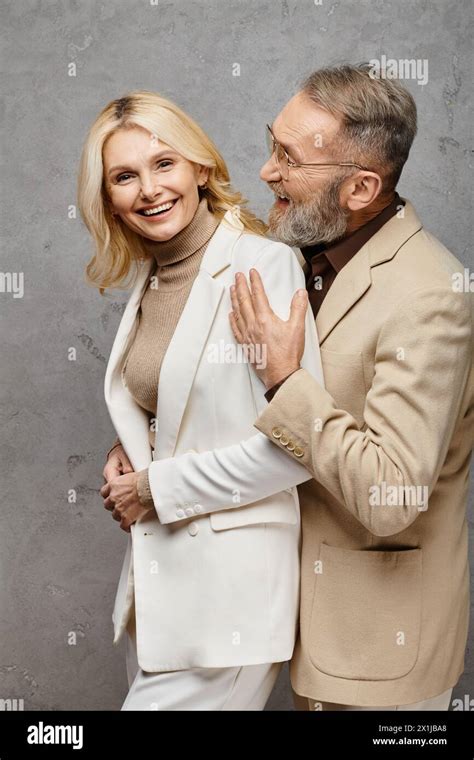 Mature Loving Couple In Debonair Attires Stand Gracefully Together