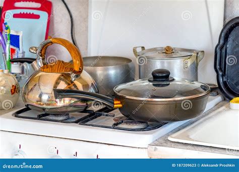 Saucepans A Frying Pan And A Kettle On Gas Stove Dishes In The