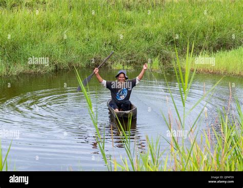 A Local Man In A Dugout Canoe Fishing In A Lake Sulawesi Indonesia