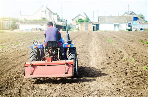 The Farmer Drives A Tractor With A Milling Unit Equipment Loosening