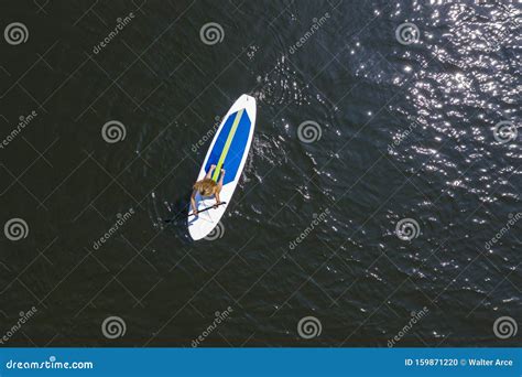 Beautiful Bikini Model Relaxing On A Paddle Board Stock Photo Image