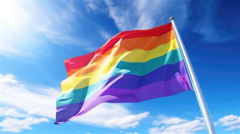 Premium Photo Gay Pride Flag Waving In The Wind Against Blue Sky