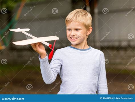 Smiling Little Boy Holding A Wooden Airplane Model Stock Photo Image