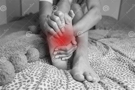 Woman Suffering from Feet Pain or Feet Ache and Massaging Painful Foot ...