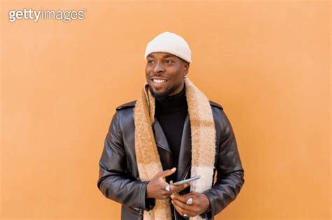 Cheerful Bearded African American Male Wearing Leather Jacket Scarf And