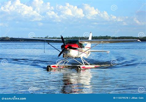 Single Engine Seaplane On Blue Waters And Blue Skies In The Background