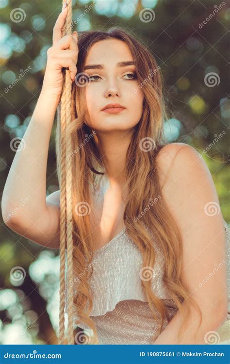 Portrait Of Beautiful Female Face Near Ropes Of Swing Girl Swinging On