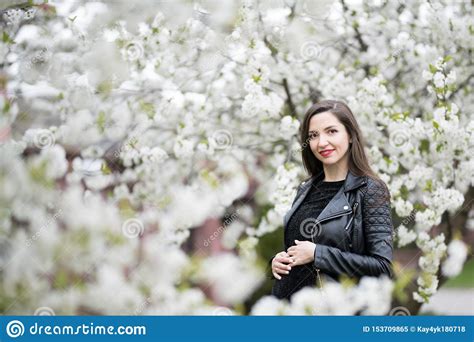 Pregnant Brunette In The Flowered Park The Brunette In A Dark Dress