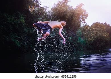 Young Boy Jumping Into Lake Stock Photo 655411258 | Shutterstock