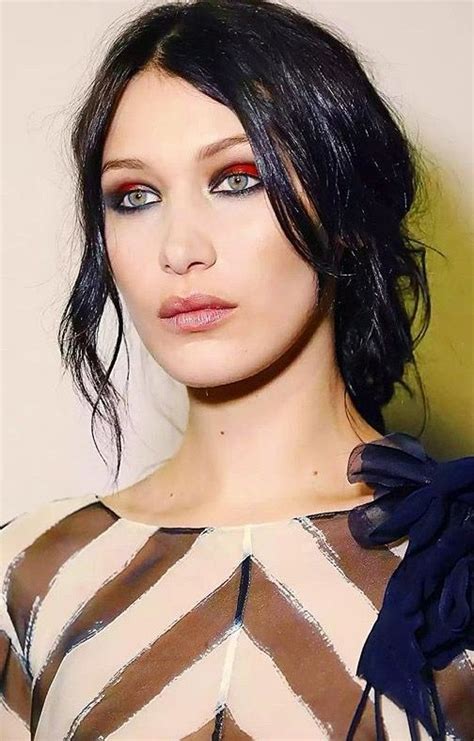 ♥ Pinterest Deborahpraha ♥ Bella Hadid Wearing Red Shimmery Eyeshadow And Loose Bun Hair Style