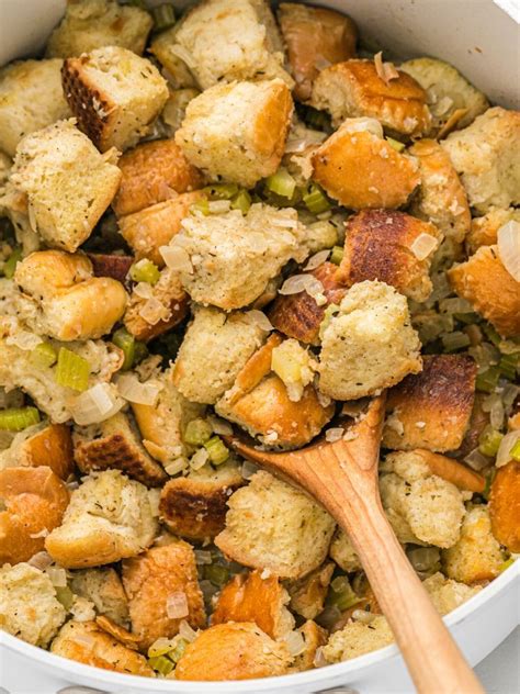 A Pot Of Stuffing With A Wooden Spoon In It Thanksgiving Recipes