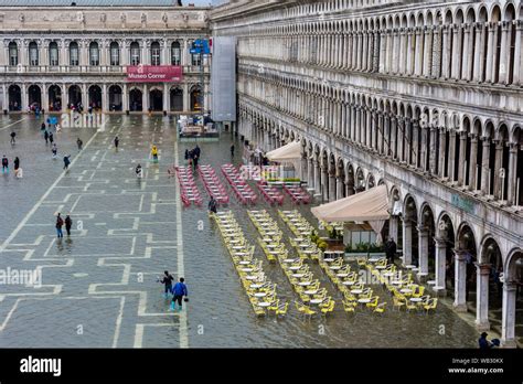 Tables And Chairs At The Procuratie Vecchie From The Basilica Di San