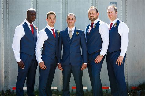 Groomsmen In Navy Suit And Vest With Marsala Ties Groom And