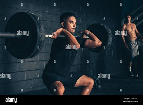 Man Lifting Barbell In Gym Stock Photo Alamy