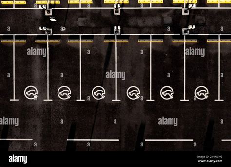 Aerial View Directly Above Rows Of Electric Vehicle Parking Spaces With Charging Stations And