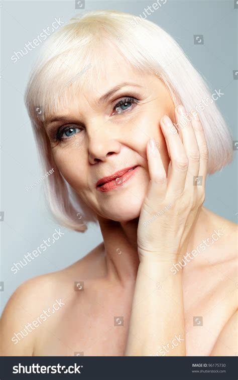 Senior Nude Woman Looking At Camera With A Charming Smile Stock Photo