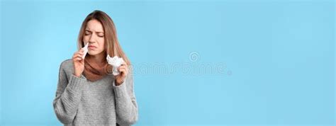 Sick Young Woman Using Nasal Spray On Light Blue Background Stock Image