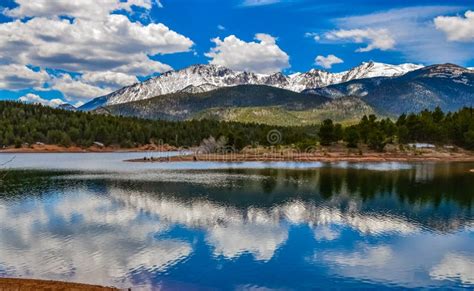 Panorama Snow Capped And Forested Mountains Near A Mountain Lake Pikes