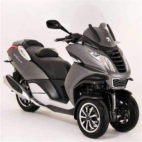 a black and silver scooter parked on top of a white floor