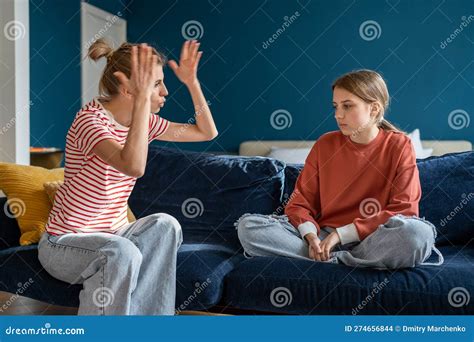 Young Angry Emotional Mother Screaming At Troubled Teen Daughter At