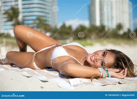 Fit Asian Woman In White Bikini Lies On The Beach Posing Stock Image