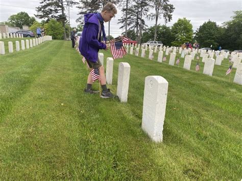 Scouts return to Dayton National Cemetery to place flags on graves