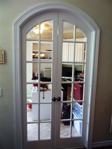 An Arched Glass Door Leading Into A Living Room