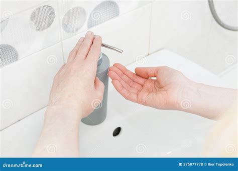 Washing Hands With Liquid Soap In A Bottle Under The Faucet Image On